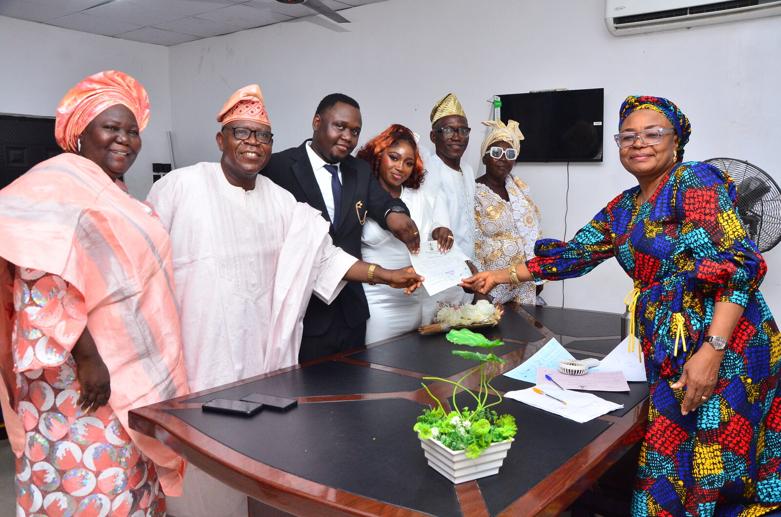 Oluwafunmibi and Olumurewa with family after their court wedding